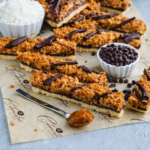 Homemade Samoas Cookie Bars with buttery crust and coconut caramel layer